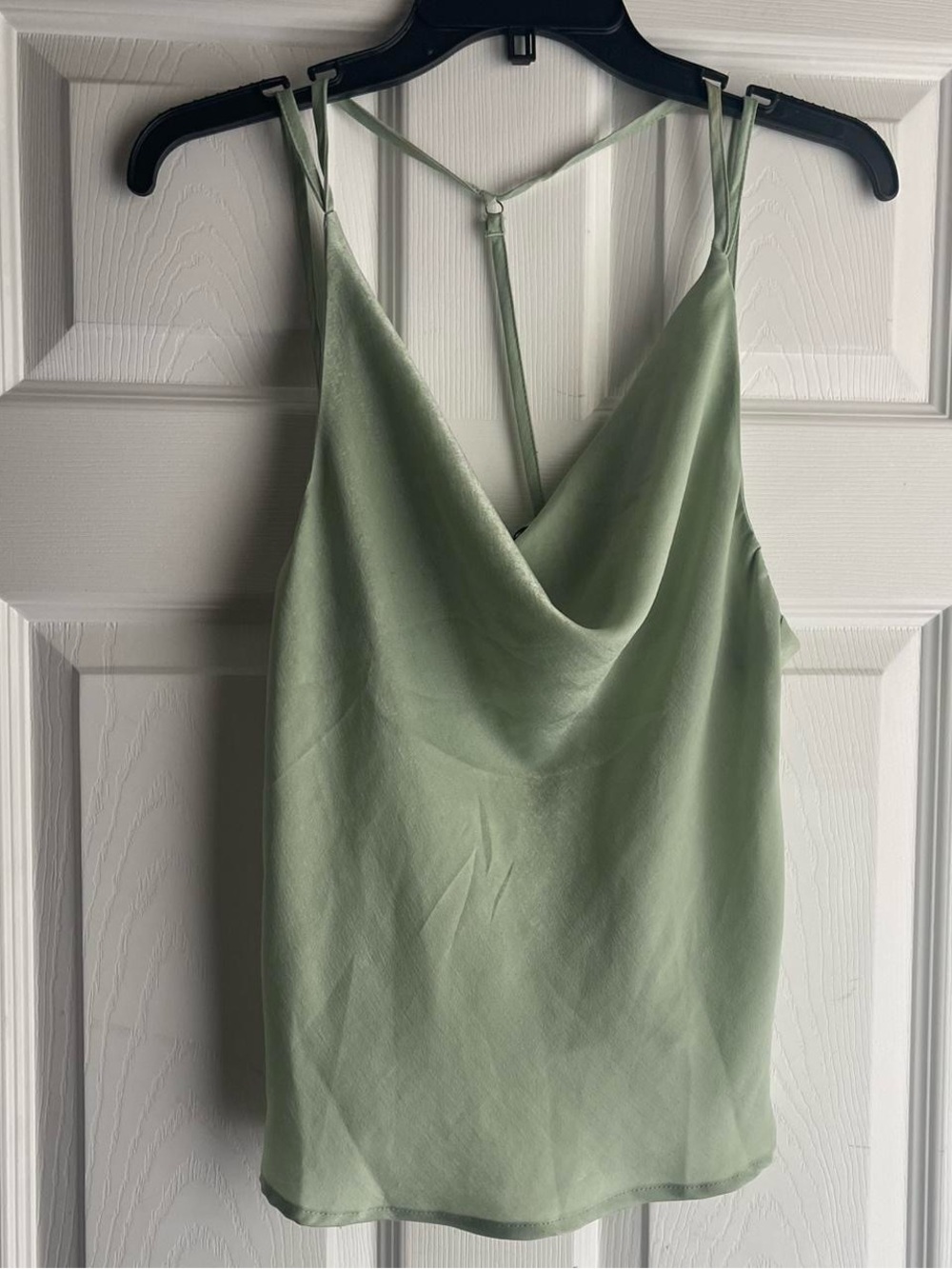 sage green satin cami top with adjustable straps and open back.